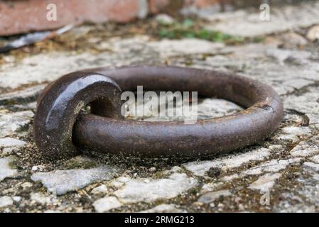 A rusty iron ring, attached to the floor. Stock Photo