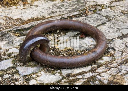 A rusty iron ring, attached to the floor. Stock Photo