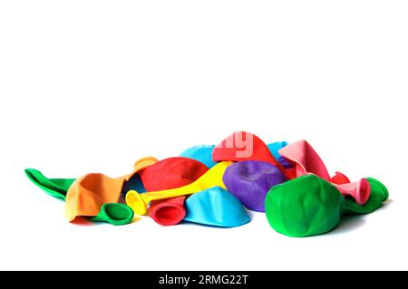 Ready for party! Many deflated colored balloons isolated on white Stock Photo