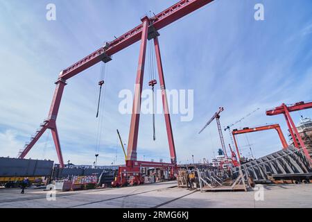 photograph of a big red crane for container ships in a import export dock Stock Photo