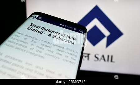 Smartphone with website of company Steel Authority of India Limited (SAIL) on screen in front of logo. Focus on top-left of phone display. Stock Photo