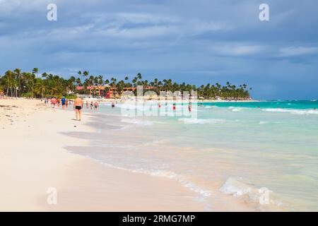 Bavaro, Dominican Republic - February 9, 2022: Tourists are on Bavaro beach on a sunny day, Caribbean resort landscape Stock Photo