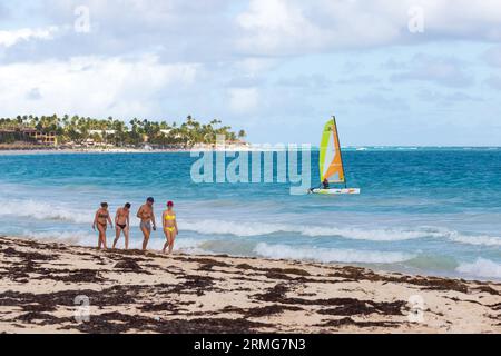 Bavaro, Dominican Republic - February 10, 2022: Caribbean landscape. Tourists walk the Bavaro beach Stock Photo