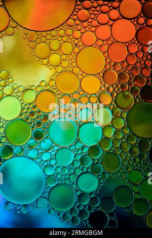 multicolored oil circles on the water, abstract background Stock Photo