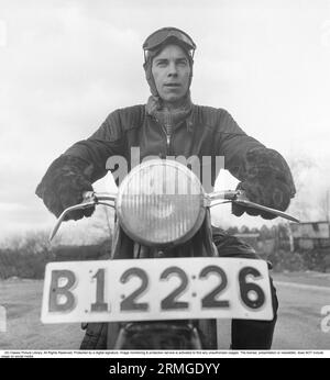 Motorcyclist in the 1950s. A young man dressed in the typical way the motorcyclists did in the 1950s. All leather. Leather boots, trousers and jacket. He is sitting on his motorcycle.  Sweden 1953. He is actor Sven-Eric Gamble, 1924-1976. Kristoffersson ref BM72-7 Stock Photo