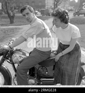 In the 1950s. A man on his Puch motorcycle with a woman sitting behind him. Sweden 1955. Stock Photo