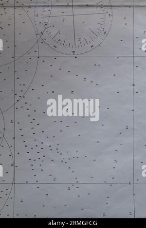 Detail of an old nautical navigational chart with compass deviation symbol on paper. Stock Photo