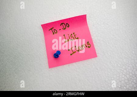 A close-up of a stack of sticky notes with to-do list items written on them Stock Photo