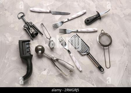 Different kitchen utensils on grey background Stock Photo