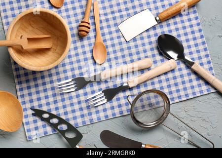 Different kitchen utensils on grey background Stock Photo