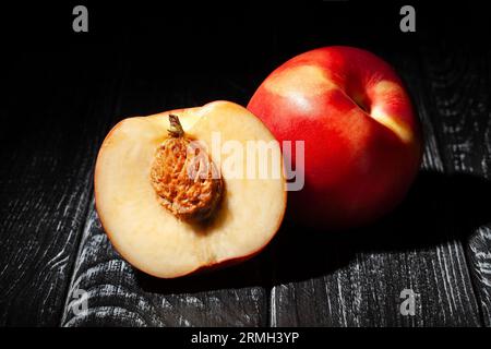 sliced white nectarine on wood background Stock Photo