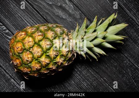 single pineapple on wood background Stock Photo