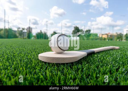 Hurling bat and sloitar on green grass. Horizontal sport theme poster ...