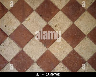 Antique terracotta tiled floor, diamond pattern Stock Photo