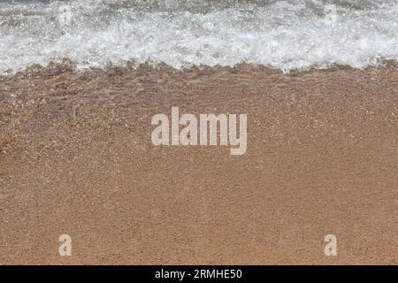 Soft Ocean Wave on Sandy Beach Stock Photo