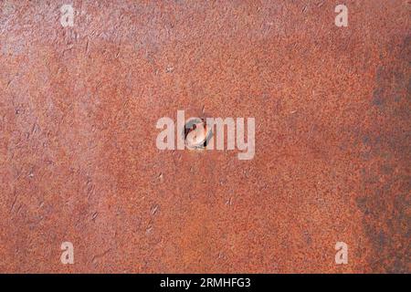 old rusty iron surface with bullet impact crater Stock Photo
