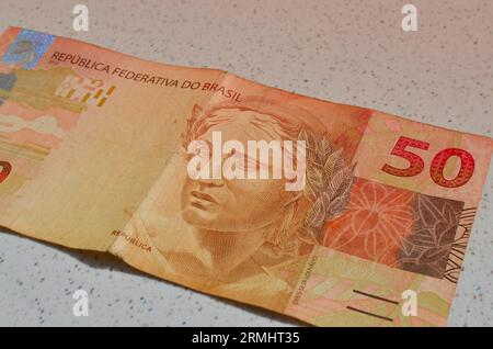 Detail of 50 reais banknote from Brazil, highlighted in Brazilian currency, perfect for financial concepts. Casa da Moeda do Brasil, representing the Stock Photo