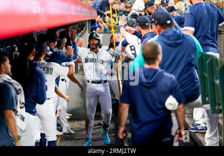 Seattle Mariners' Julio Rodríguez holds a trident in the dugout after  hitting a home run in a baseball game against the Texas Rangers, Thursday,  Sept. 28, 2023, in Seattle. (AP Photo/Lindsey Wasson