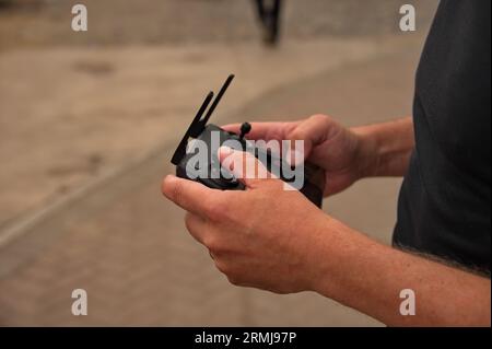 Closeup of man's hands holding the remote control of drone Stock Photo