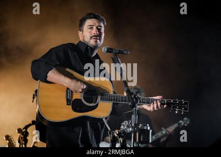 Portsmouth, UK. 27th Aug, 2023. Marcus Mumford, lead vocals, electric guitar, acoustic guitar, and drummer with British folk rock band, Mumford & Sons performing live on stage at Victorious Festival. (Photo by Dawn Fletcher-Park/SOPA Images/Sipa USA) Credit: Sipa USA/Alamy Live News Stock Photo