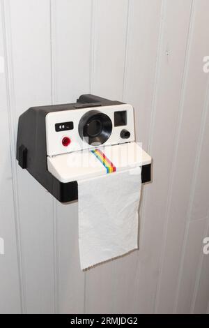 Bordeaux , France -  08 28 2023 : Polaroid toilet paper dispenser on wooden wc wall interior in instant print camera shaped toilet paper holder Stock Photo