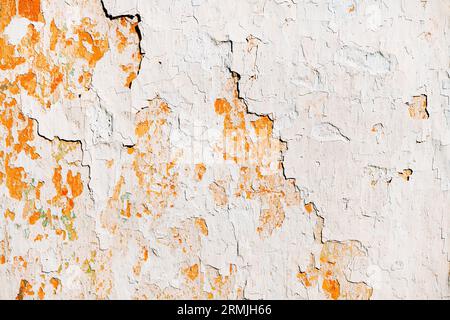Old cracked weathered shabby white painted plastered peeled wall background and texture Stock Photo