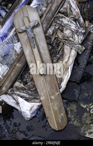 Burnt coffin wit0h flowers in cemetery, religion and burial Stock Photo