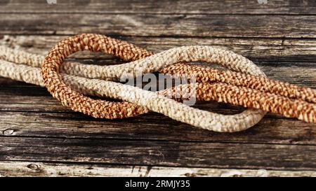 Tied ropes standing on wooden background. 3D illustration. Stock Photo