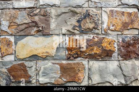 Textured crude stone wall close-up Stock Photo