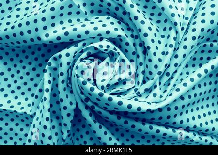 Draped blue silk with polka dots as a background Stock Photo