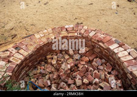 Building compact brick water harvesting tanks in rural Uttarakhand, India, for sustainable water conservation. Stock Photo