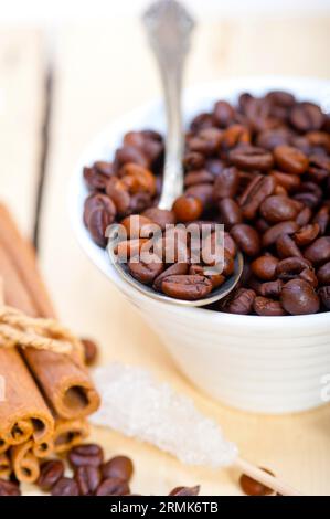 Coffe sugar and spice on silver spoon over white wood rustic table Stock Photo
