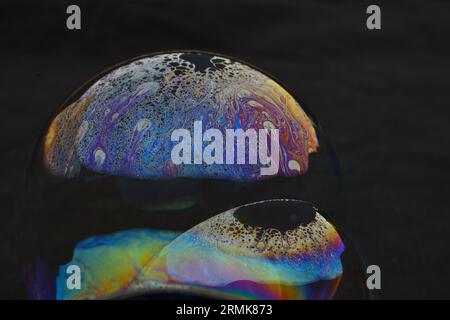 Beautiful psychedelic abstractions on the surface soap bubbles Stock Photo