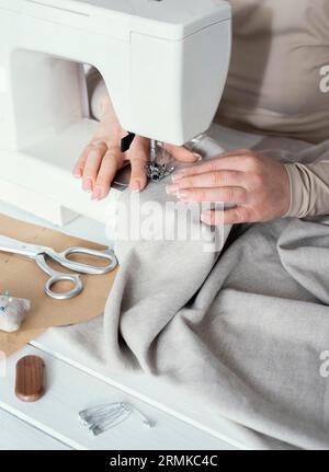 High angle seamstress using sewing machine Stock Photo