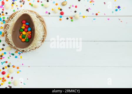 Small candies open easter chocolate egg table Stock Photo