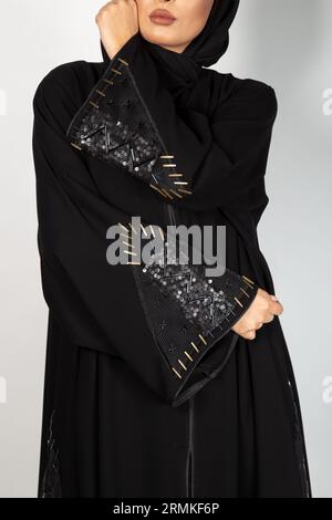 Asian Model poses for Arabic designer Abaya on isolated background. Fashion Concept Stock Photo