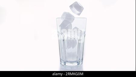 Ice Cubes Falling into Glass against White Background Stock Photo - Alamy
