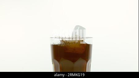 Ice Cubes Falling into Glass of Coke against White Background Stock ...