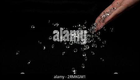 Hand of Woman with Diamonds against Black Background Stock Photo