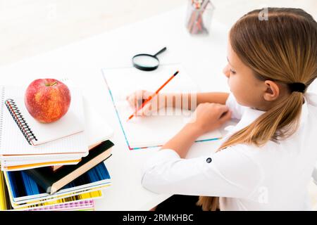 Cute girl uniform studying desk Stock Photo