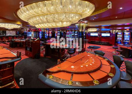 Las Vegas, Nevada, USA, March 10, 2023: Casino gambling blackjack and slot machines waiting for gamblers and tourist to spend money Stock Photo