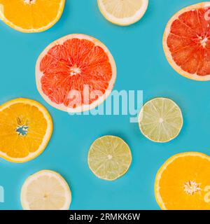 Slice various citrus fruits blue surface Stock Photo
