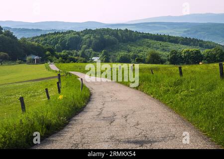 Dirty road between pasture, hills on background, Lipa near Zlin, Czech republic. Stock Photo