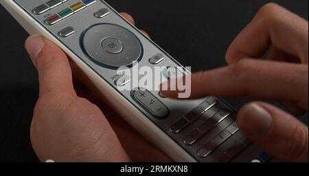 Hands of Woman with remote control Stock Photo