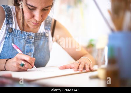 Close-up of illustrator drawing in pencil on a blank sheet of paper. Stock Photo