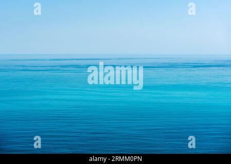 Empty Blue Ocean or Sea and Blue Sky. Feeling calm, cool, relaxing. The idea for blue background and copy space on the top. Stock Photo