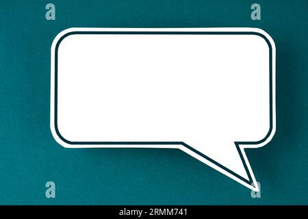 Blank white speech bubble on a green background for your text. Stock Photo