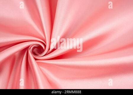 Abstract Rose gold Satin Silky Cloth for background, Fabric Textile Drape with Crease Wavy Folds.with soft waves is rose flower. Stock Photo