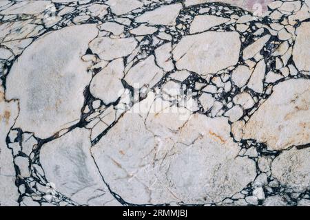 A mesmerizing blend of textures and patterns on a stone surface, where marble columns and walls come together in captivating architectural harmony. Stock Photo