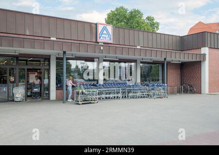 Aldi store in Berlin Germany. Two customers in front of the store. Stock Photo